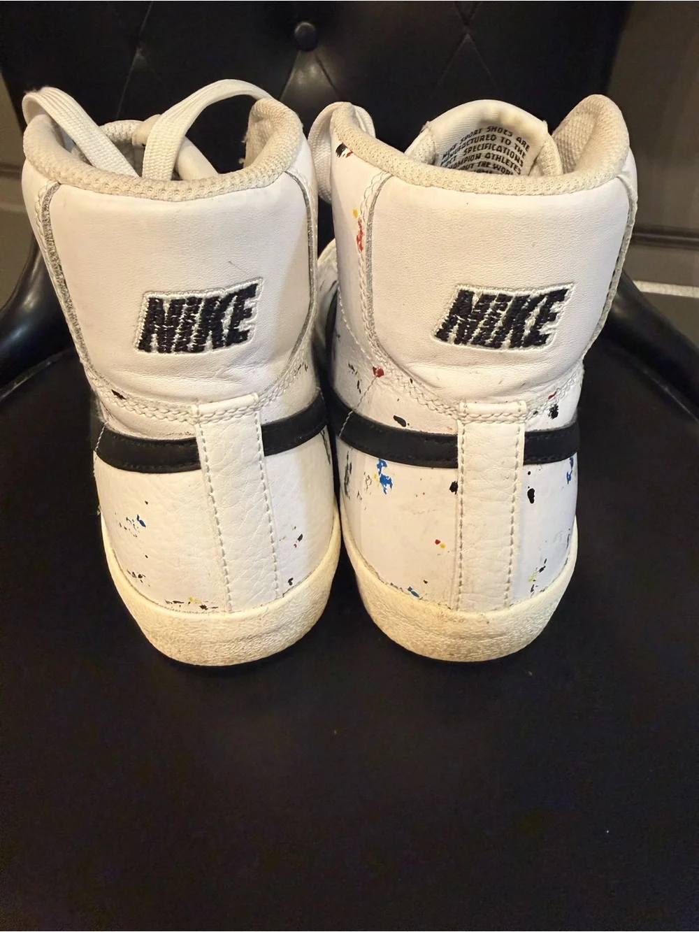 Nike White High-Top Sneakers with Black Swoosh and Paint Splatter